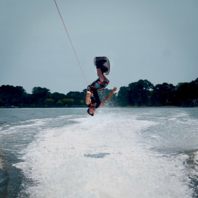 a man flying a kite in a body of water