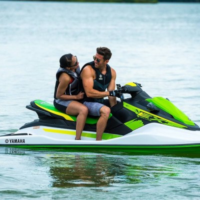 a person riding on the back of a boat in a body of water