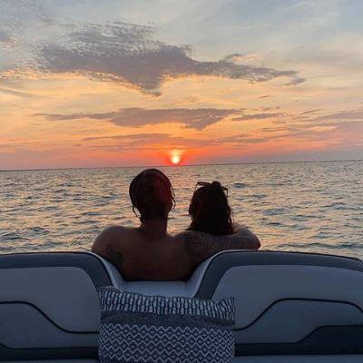 a person sitting on a beach near a body of water