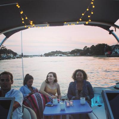 a group of people sitting in front of a body of water