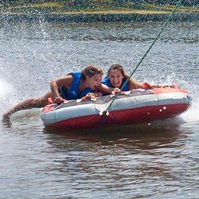 a person riding on the back of a boat in a body of water