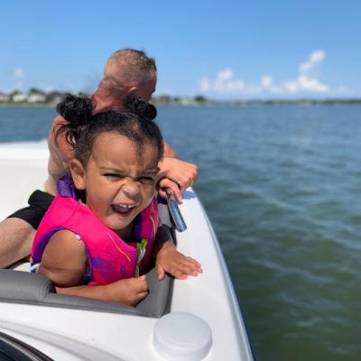 a person sitting in a boat on a body of water