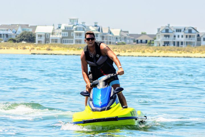 a man riding on the back of a jet ski in the water
