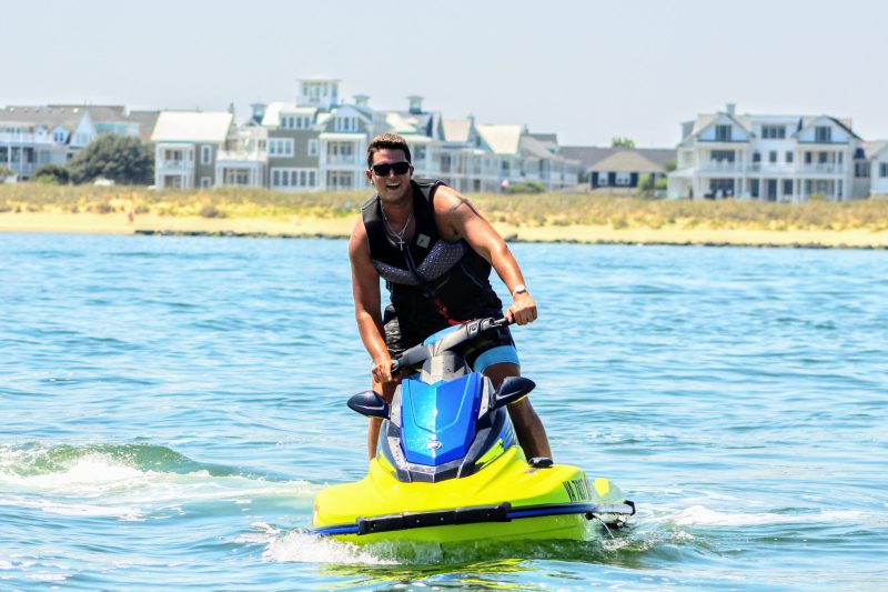 IMG_6330 a man riding on the back of a jet ski in the water