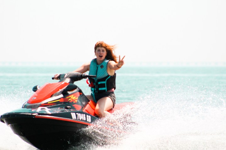 a girl riding a wave on top of a jet ski in the chesapeake bay