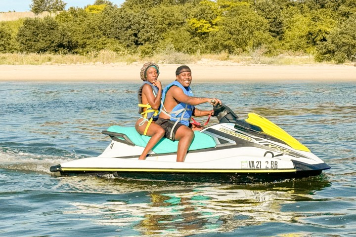 a person riding on the back of a boat in the water